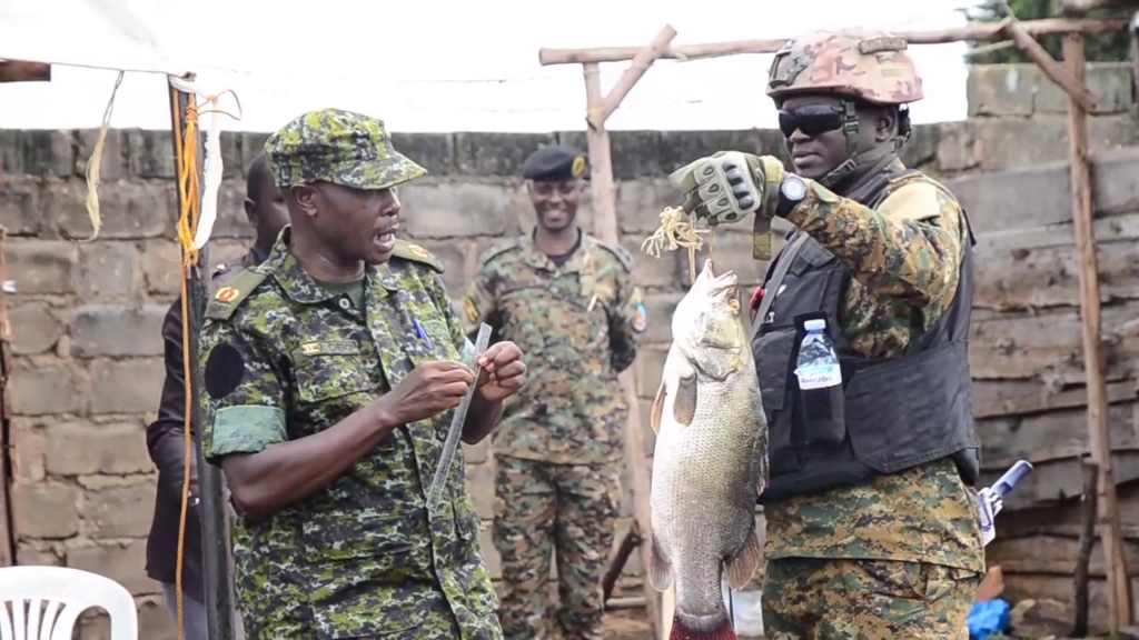 Fisheries Protection Unit showing fishermen the right size of fish Authorized.