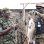 Fisheries Protection Unit showing fishermen the right size of fish Authorized.