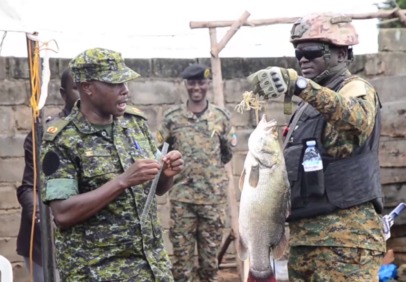 Fisheries Protection Unit showing fishermen the right size of fish Authorized.